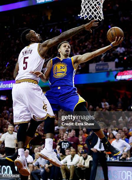 Stephen Curry of the Golden State Warriors goes up against J.R. Smith of the Cleveland Cavaliers in the second quarter during Game Six of the 2015...