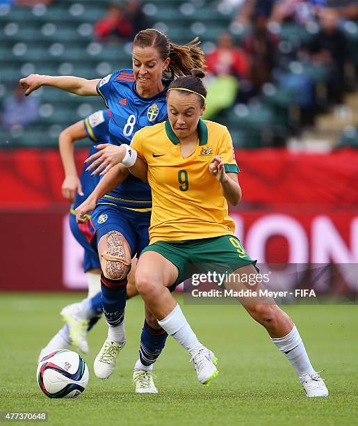 Lotta Schelin of Sweden defends Caitlin Foord of Australia during the Women's World Cup 2015 Group D match at Commonwealth Stadium on June 16, 2015...