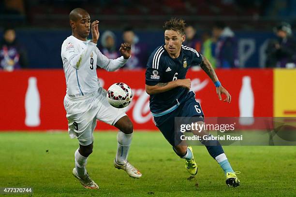 Lucas Biglia of Argentina fights for the ball with Diego Rolan of Uruguay during the 2015 Copa America Chile Group B match between Argentina and...