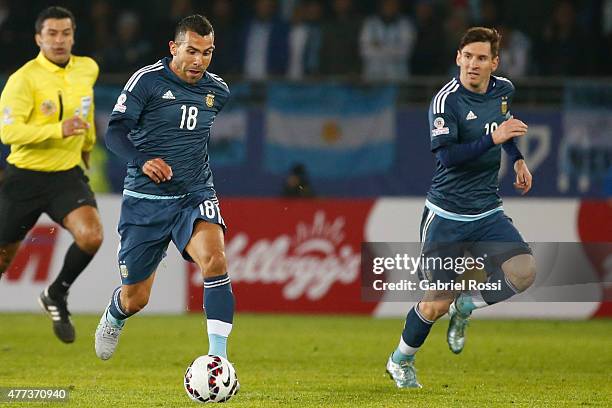 Carlos Tevez of Argentina drives the ball next to Lionel Messi during the 2015 Copa America Chile Group B match between Argentina and Uruguay at La...