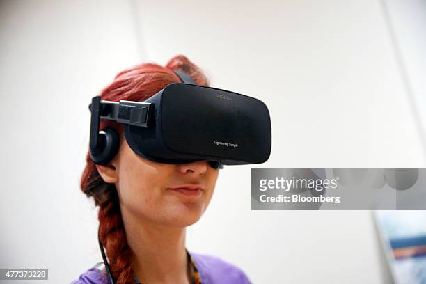 Anna Brisbin plays a video game on an Oculus Rift virtual reality headset during the E3 Electronic Entertainment Expo in Los Angeles, California,...