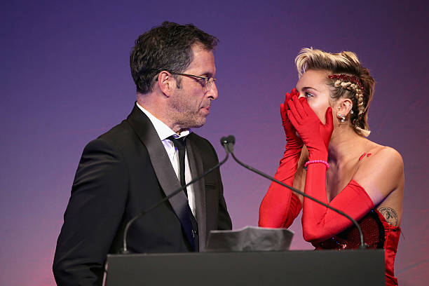 Kenneth Cole and Miley Cyrus speak onstage at the 2015 amfAR Inspiration Gala New York at Spring Studios on June 16, 2015 in New York City.