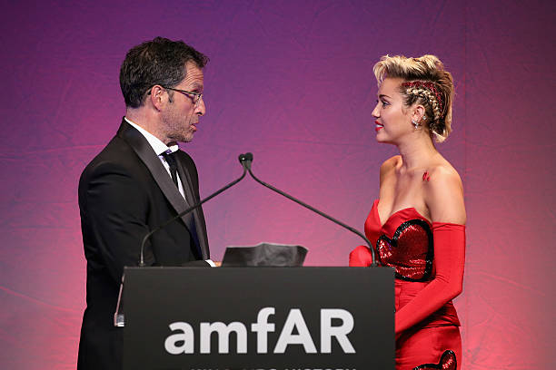 Kenneth Cole and Miley Cyrus speak onstage at the 2015 amfAR Inspiration Gala New York at Spring Studios on June 16, 2015 in New York City.