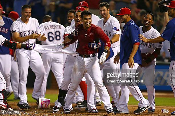 Robinson Chirinos of the Texas Rangers celebrates after hitting a walk-off home run in the ninth inning during a game against the Los Angeles Dodgers...
