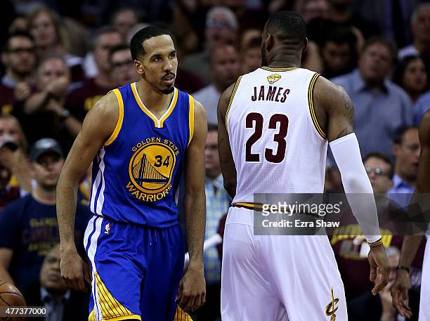 Shaun Livingston of the Golden State Warriors stares down LeBron James of the Cleveland Cavaliers after dunking in the fourth quarter during Game Six...