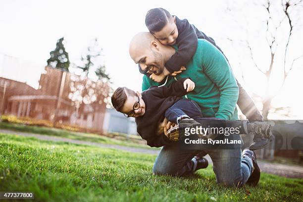 dad playing outside with his boys - rough housing stock pictures, royalty-free photos & images
