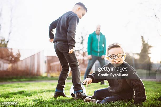 dad playing soccer with his sons - rough housing stock pictures, royalty-free photos & images