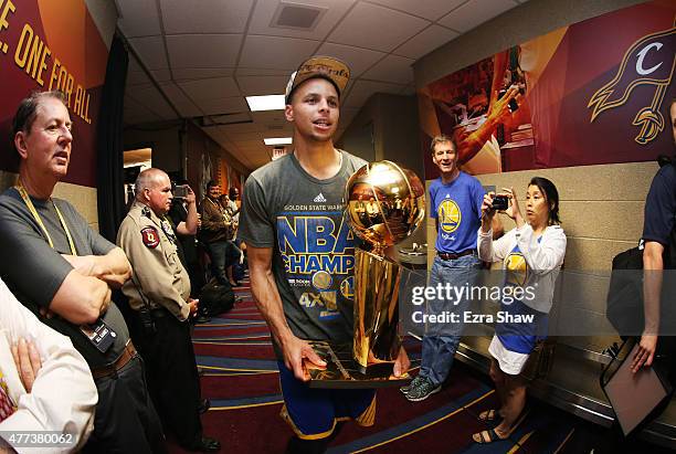 Stephen Curry of the Golden State Warriors celebrates with the Larry O'Brien NBA Championship Trophy after defeating the Cleveland Cavaliers in Game...