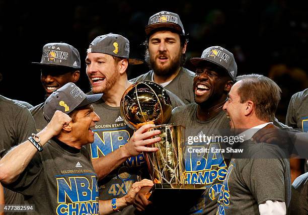 Draymond Green David Lee and Andrew Bogut of the Golden State Warriors celebrates with team owners Peter Guber and Joe Lacob and the Larry O'Brien...