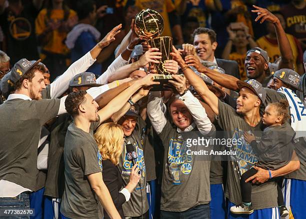 Players of Golden State Warriors celebrate their winning over the Cavaliers, and win the NBA Championship Trophy in Cleveland on June 16, 2015. The...