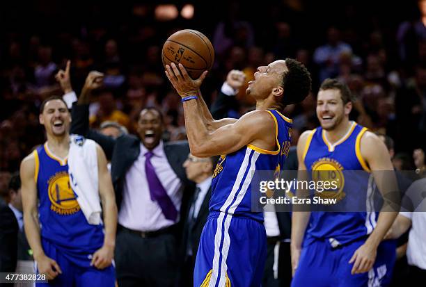 Stephen Curry celebrates with David Lee and Festus Ezeli of the Golden State Warriors as the defeated the Cleveland Cavaliers 105 to 97 during Game...