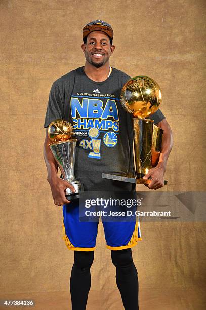 Andre Iguodala of the Golden State Warriors poses for a portrait with the Larry O'Brien trophy and Bill Russell MVP Award after defeating the...