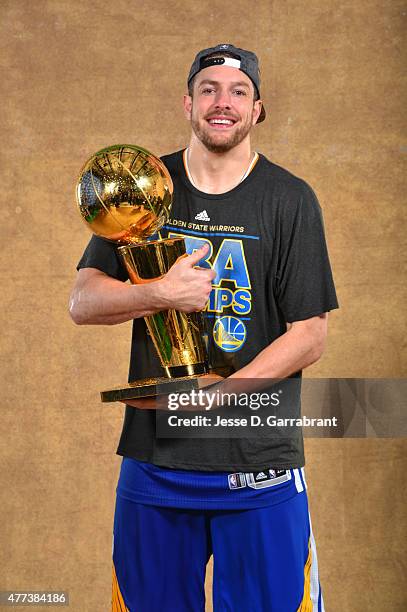 David Lee of the Golden State Warriors poses for a portrait with the Larry O'Brien trophy after defeating the Cleveland Cavaliers in Game Six of the...