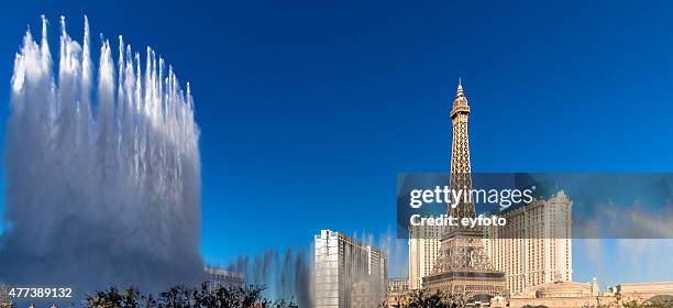 paris las vegas with fountains and rainbow (panoramic view) - las vegas skyline stock pictures, royalty-free photos & images