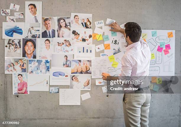 creative business man creating a wall chart - market research stock pictures, royalty-free photos & images