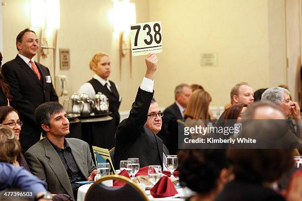 Guest bids on an item during an auction at the PARS Equality Center 4th Annual Nowruz Gala at Marriott Waterfront Burlingame Hotel on March 8, 2014...