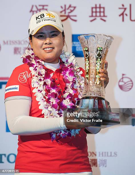Inbee Park of South Korea poses with the trophy after winning the World Ladies Championship at Mission Hills' Blackstone Course on March 9, 2014 in...