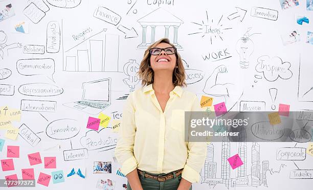 creative business woman thinking - wall of sticky notes stock pictures, royalty-free photos & images