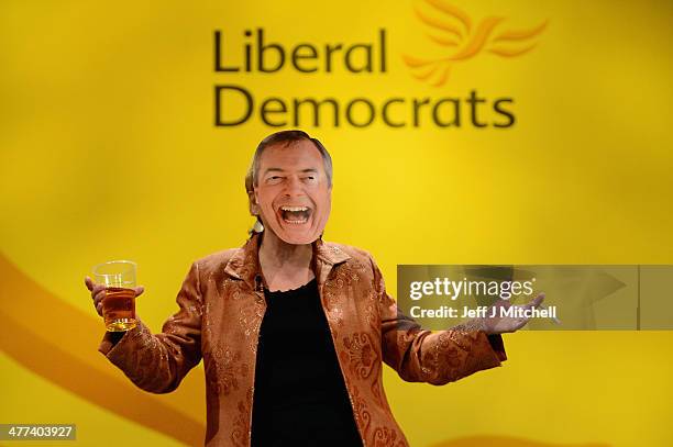 Lorley Burt MP for Solihull, walks on stage wearing a Nigel Farage mask, prior to Nick Clegg deputy prime minister and leader of the Liberal...