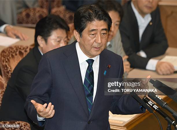 Japanese Prime Minister Shinzo Abe gestures as he answers questions from leader of the main opposition Democratic Party of Japan Katsuya Okada during...