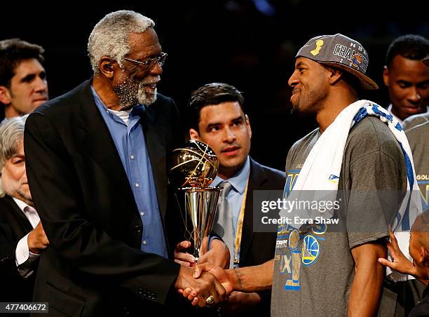 Bill Russell and Andre Iguodala of the Golden State Warriors shake hands after he receives the 2015 NBA Finals MVP award following their win over the...