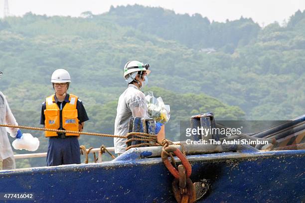 Bereaved family members and staffs attend a memorial service for the sunken Daiichi Genpuku Maru at Hamada Port on June 17, 2015 in Hamada, Shimane,...