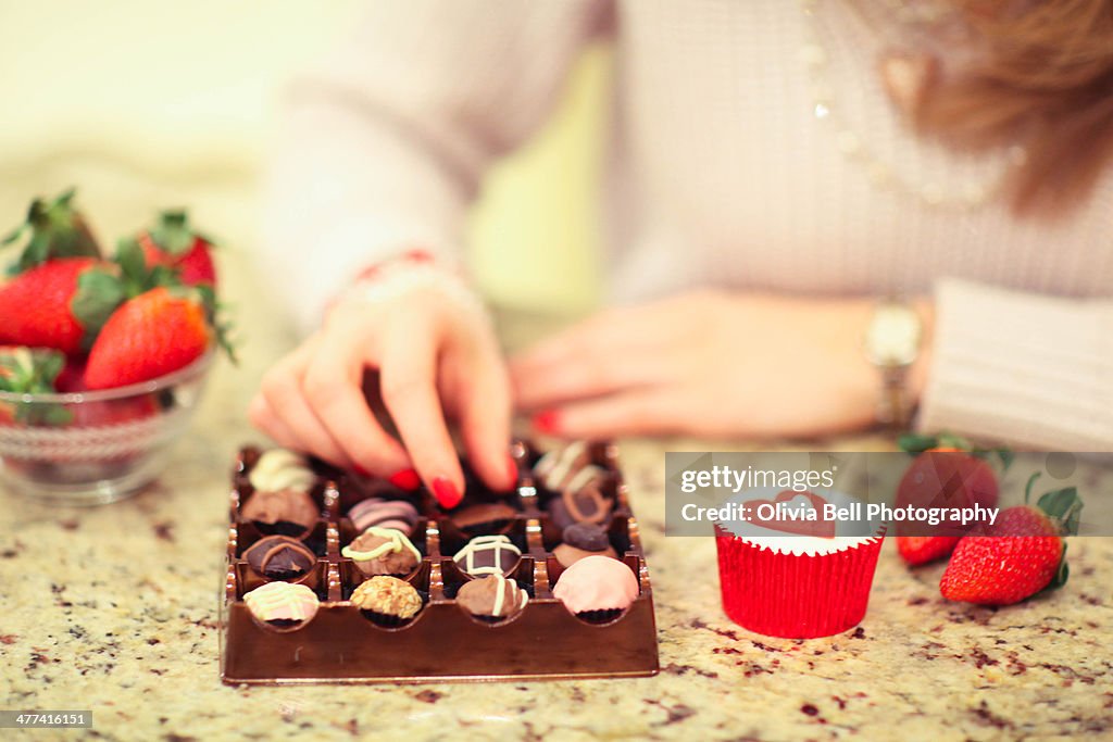 Girl Eating Luxury Chocolates and Strawberries