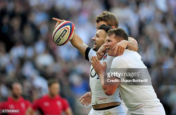 Danny Care of England celebrates with Joe Launchbury and Dylan Hartley as he scores their first try during the RBS Six Nations match between England...