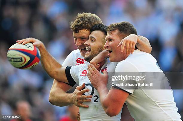 Danny Care of England celebrates with Joe Launchbury and Dylan Hartley as he scores their first try during the RBS Six Nations match between England...