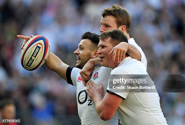 Danny Care of England celebrates with Joe Launchbury and Dylan Hartley as he scores their first try during the RBS Six Nations match between England...