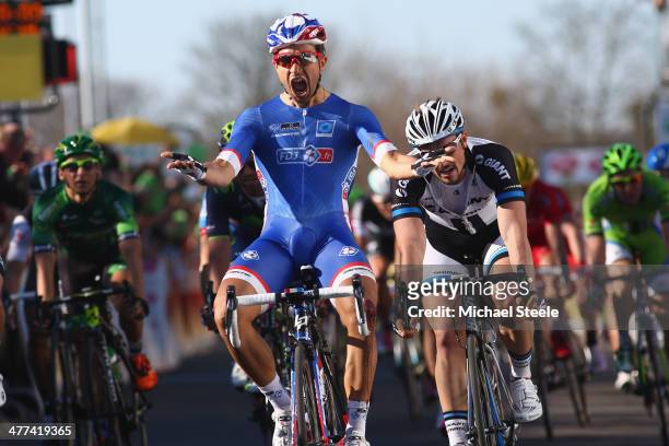 Nacer Bouhanni of France and Team FDJ celebrates winning in a sprint finish during Stage 1 of the Paris-Nice race on March 9, 2014 in...