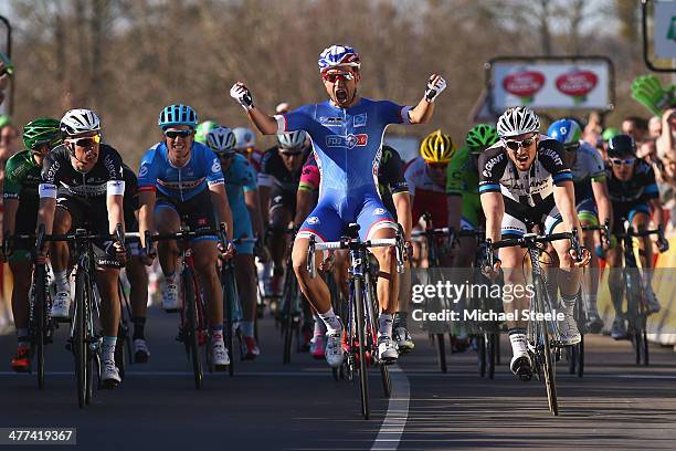 Nacer Bouhanni of France and Team FDJ celebrates winning in a sprint finish during Stage 1 of the Paris-Nice race on March 9, 2014 in...