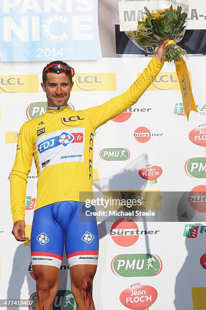 Nacer Bouhanni of France and Team FDJ celebrates victory and dons the leaders yellow jersey on the podium after Stage 1 of the Paris-Nice race on...