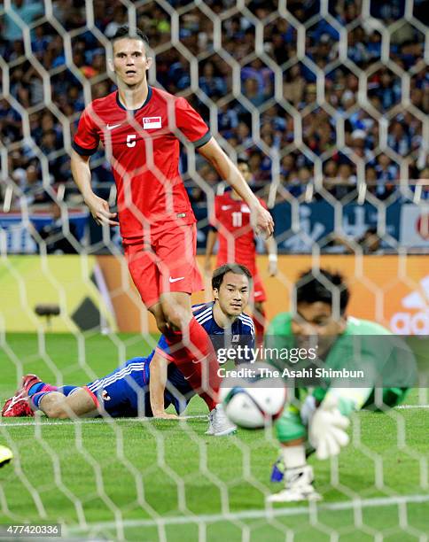 Shinji Okazaki of Japan watches the ball saved by Mohamad Izwan Bin Mahbud of Singapore during the 2018 FIFA World Cup Asian Qualifier second round...