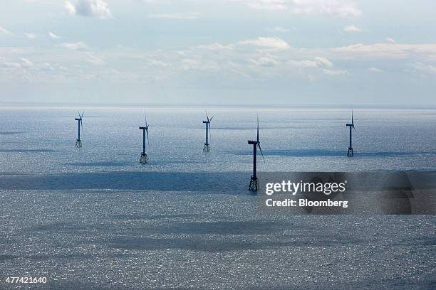 Wind turbines stand in the North Sea at the Nordsee OST off-shore wind park, operated by RWE AG, off the coast of the Heligoland archipelago in...