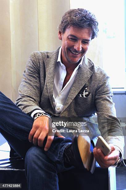 Actor Roberto Farnesi takes a photo to his shoes at Cuoio di Toscana during the Pitti Uomo 88 at Fortezza da Basso on June 16, 2015 in Florence,...