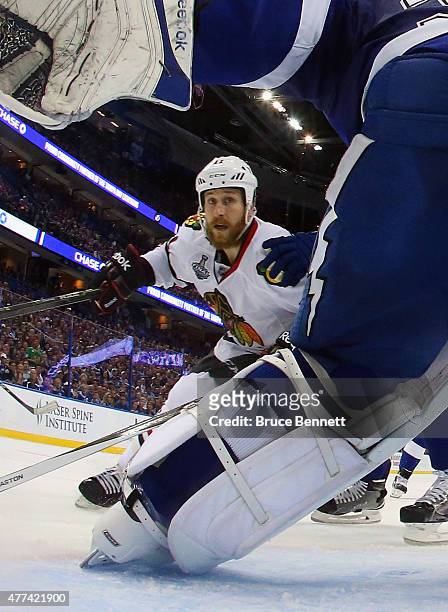Andrew Desjardins of the Chicago Blackhawks skates in on Ben Bishop of the Tampa Bay Lightning during Game Five of the 2015 NHL Stanley Cup Final at...