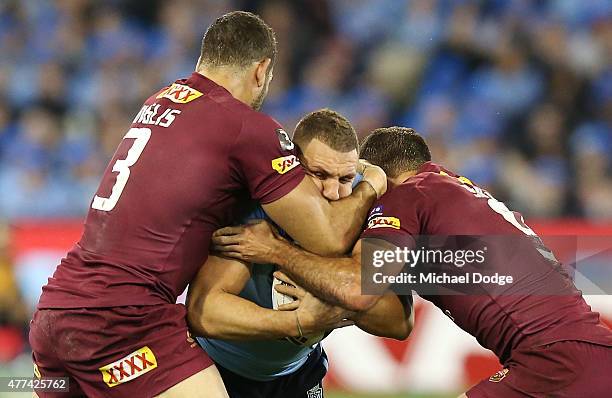 Robbie Farah of the Blues is tackled by Greg Inglis of the Maroons and Cameron Smith during game two of the State of Origin series between the New...