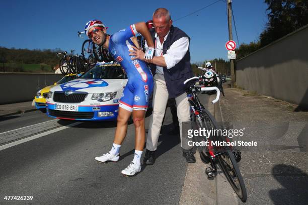 Nacer Bouhanni of France and Team FDJ and eventual stage victor is helped onto his feet after crashing during Stage 1 of the Paris-Nice race on March...