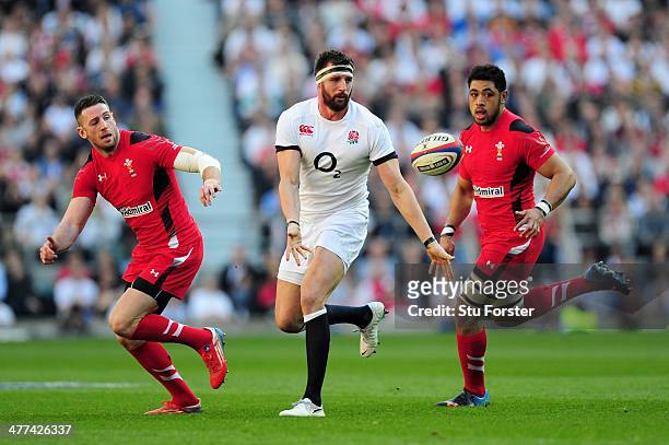 Tom Wood of England is tracked by Alex Cuthbert and Toby Faletau of Wales during the RBS Six Nations match between England and Wales at Twickenham...