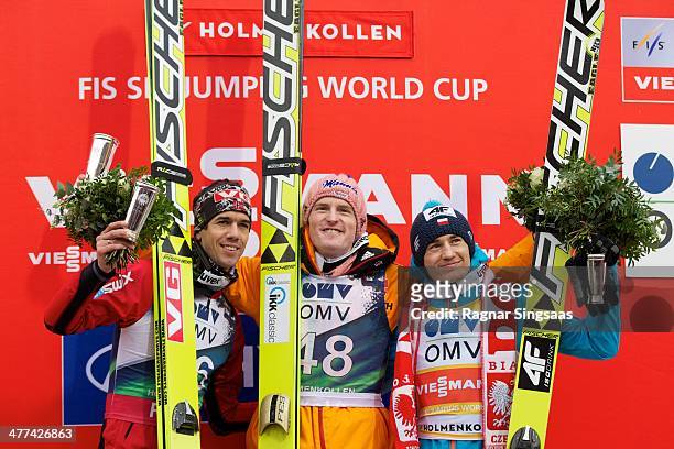 Anders Bardal of Norway takes second place, Severin Freund of Germany takes first place and Kamil Stoch of Poland takes third place during the FIS...