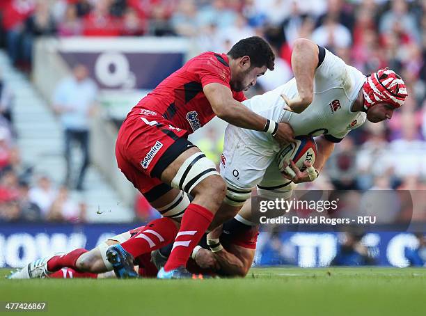 Ben Morgan of England is tackled by Toby Faletau of Wales during the RBS Six Nations match between England and Wales at Twickenham Stadium on March...