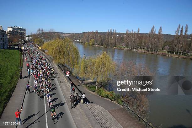 The peloton pass the River Seine during Stage 1 of the Paris-Nice race on March 9, 2014 in Mantes-la-Jolie, France.