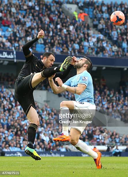 Alvaro Negredo of Manchester City battles with Ivan Ramis of Wigan Athletic during the FA Cup Quarter-Final match between Manchester City and Wigan...