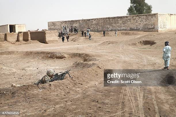 Wilmer Bolivar from Pembroke Pines, Florida with the U.S. Army's 4th squadron 2d Cavalry Regiment keeps watch during a patrol through a village on...