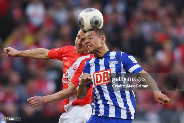Marcel Ndjeng of Berlin jumps for a header with Zdenek Pospech of Mainz during the Bundesliga match between 1. FSV Mainz 05 and Hertha BSC Berlin at...