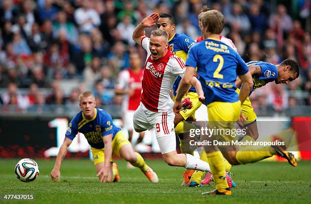 Kolbeinn Sigthorsson of Ajax falls under the tackle but no fouls is given during the Eredivisie match between Ajax Amsterdam and SC Cambuur...