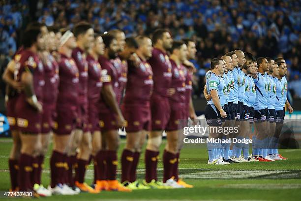 Maroons and Blues players stand for the national anthem during game two of the State of Origin series between the New South Wales Blues and the...