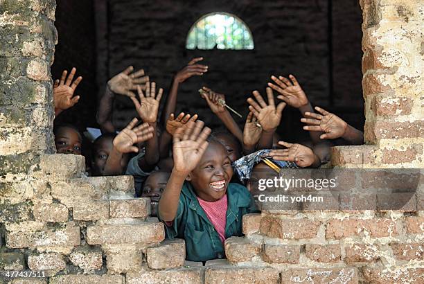 children say hello from african school - african school kids stockfoto's en -beelden