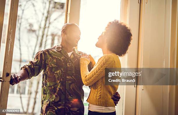 Happy African American soldier coming home to his wife.